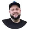 Smiling man wearing dark baseball cap and black t-shirt in circular profile photo for TixTown event management app